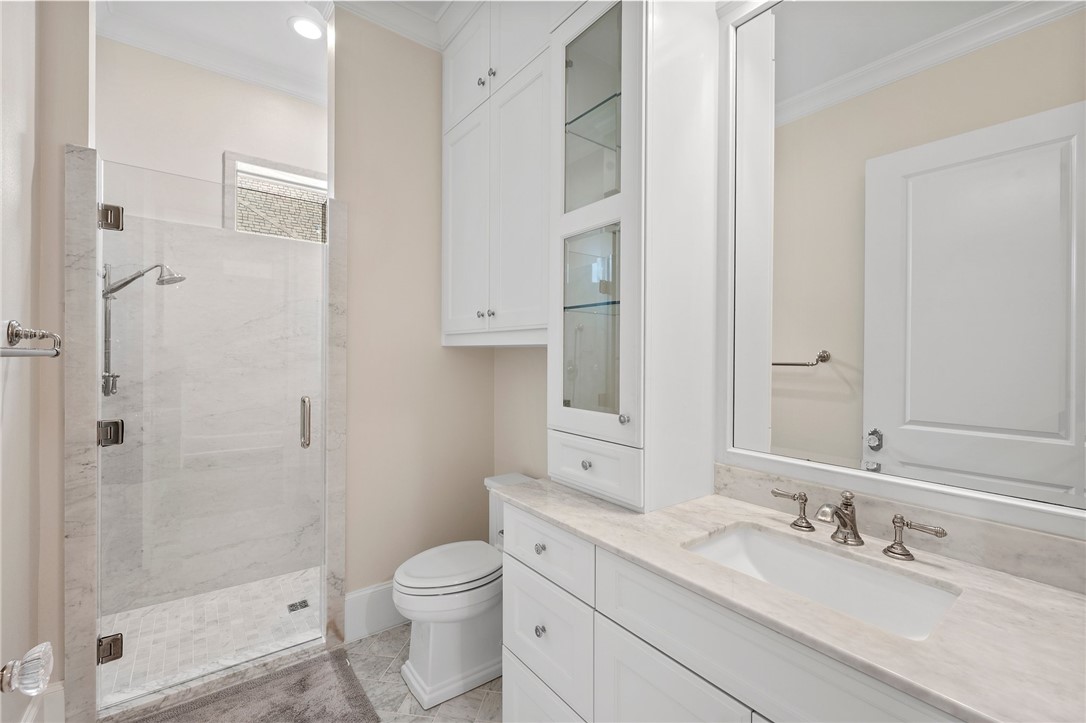 5108 Inverness Drive Bryan, TX 77802 - Photo 23 of 34 a bathroom with a granite countertop sink a toilet and shower