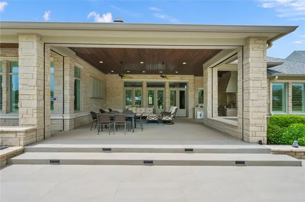 a view of a house with swimming pool and porch with a table