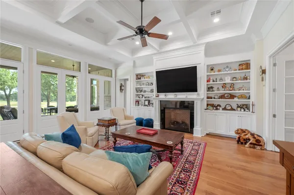 a living room with furniture fireplace and a table