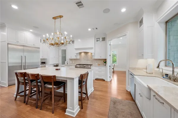 a large kitchen with a table and chairs