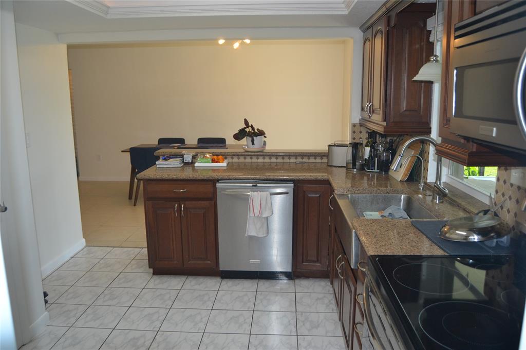 5241 Southwest 89th Avenue Cooper City, FL 33328 - Photo 11 of 28 a kitchen with a stove and a sink