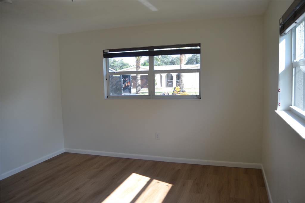 5241 Southwest 89th Avenue Cooper City, FL 33328 - Photo 12 of 28 an empty room with wooden floor and windows