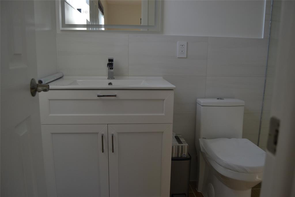 5241 Southwest 89th Avenue Cooper City, FL 33328 - Photo 15 of 28 a bathroom with a sink a toilet and a mirror