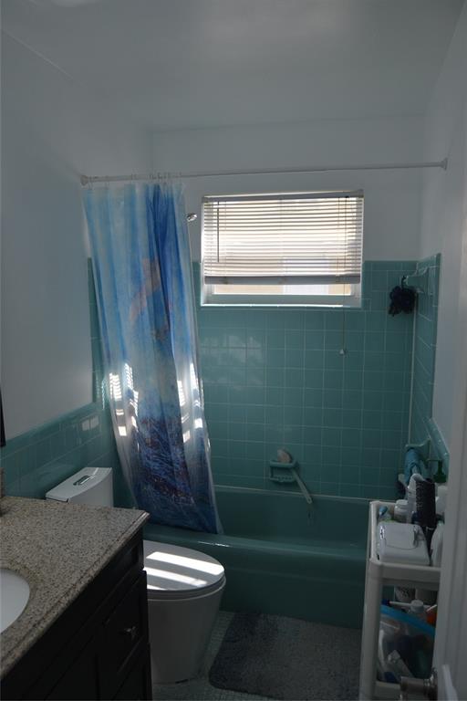 5241 Southwest 89th Avenue Cooper City, FL 33328 - Photo 22 of 28 a bathroom with a granite countertop sink a toilet a mirror and bathtub