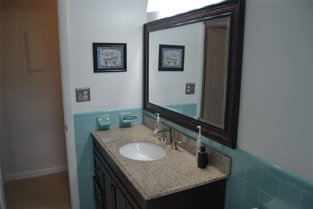 5241 Southwest 89th Avenue Cooper City, FL 33328 - Photo 23 of 28 a bathroom with a granite countertop sink and a mirror