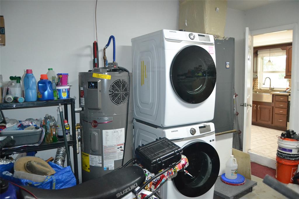 5241 Southwest 89th Avenue Cooper City, FL 33328 - Photo 24 of 28 a utility room with dryer washer and a view of living room