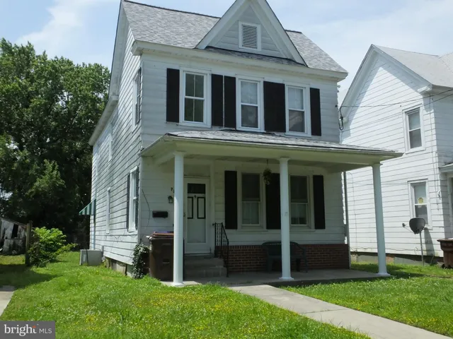 a view of a brick house with a yard