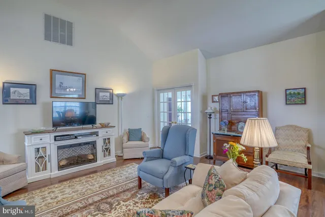 a view of a patio with couches chairs and wooden floor