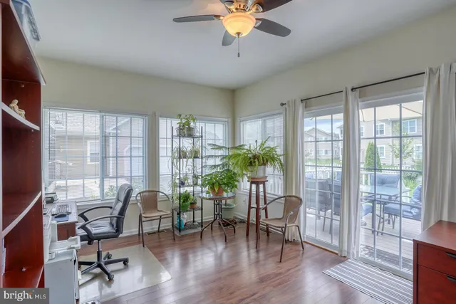 a view of a dining room with furniture wooden floor and chandelier