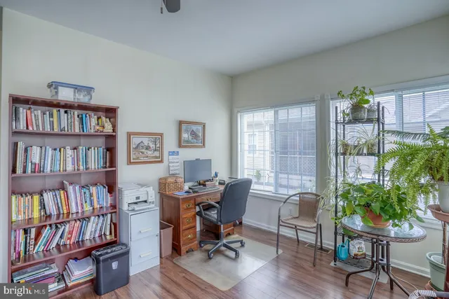 a bedroom with a bed and a dresser next to a window