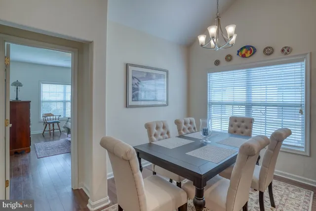 a kitchen that has a sink a stove and chairs