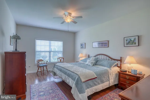 a kitchen with stainless steel appliances a dining table chairs and a refrigerator
