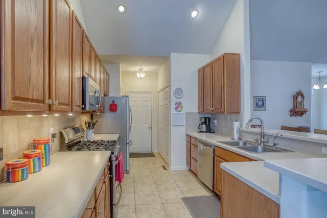 an aerial view of a house with a garden and lake view