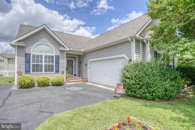 a living room with furniture a flat screen tv and a floor to ceiling window