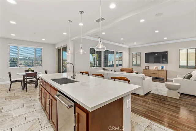 a large kitchen with kitchen island a sink table and chairs