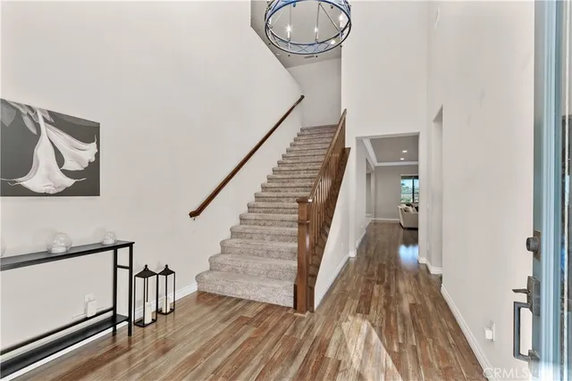 a view of a hallway with wooden floor and staircase