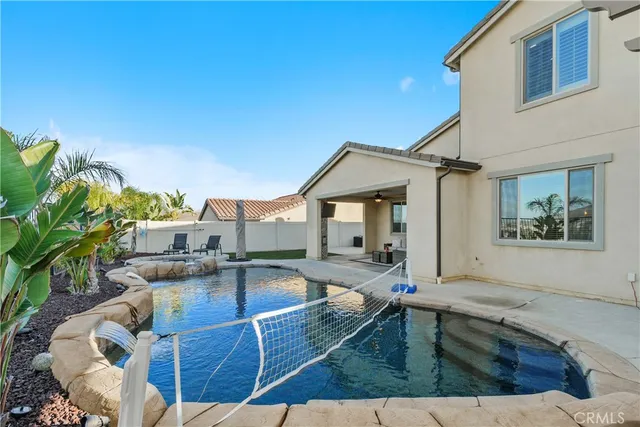 a view of a house with pool porch and sitting area