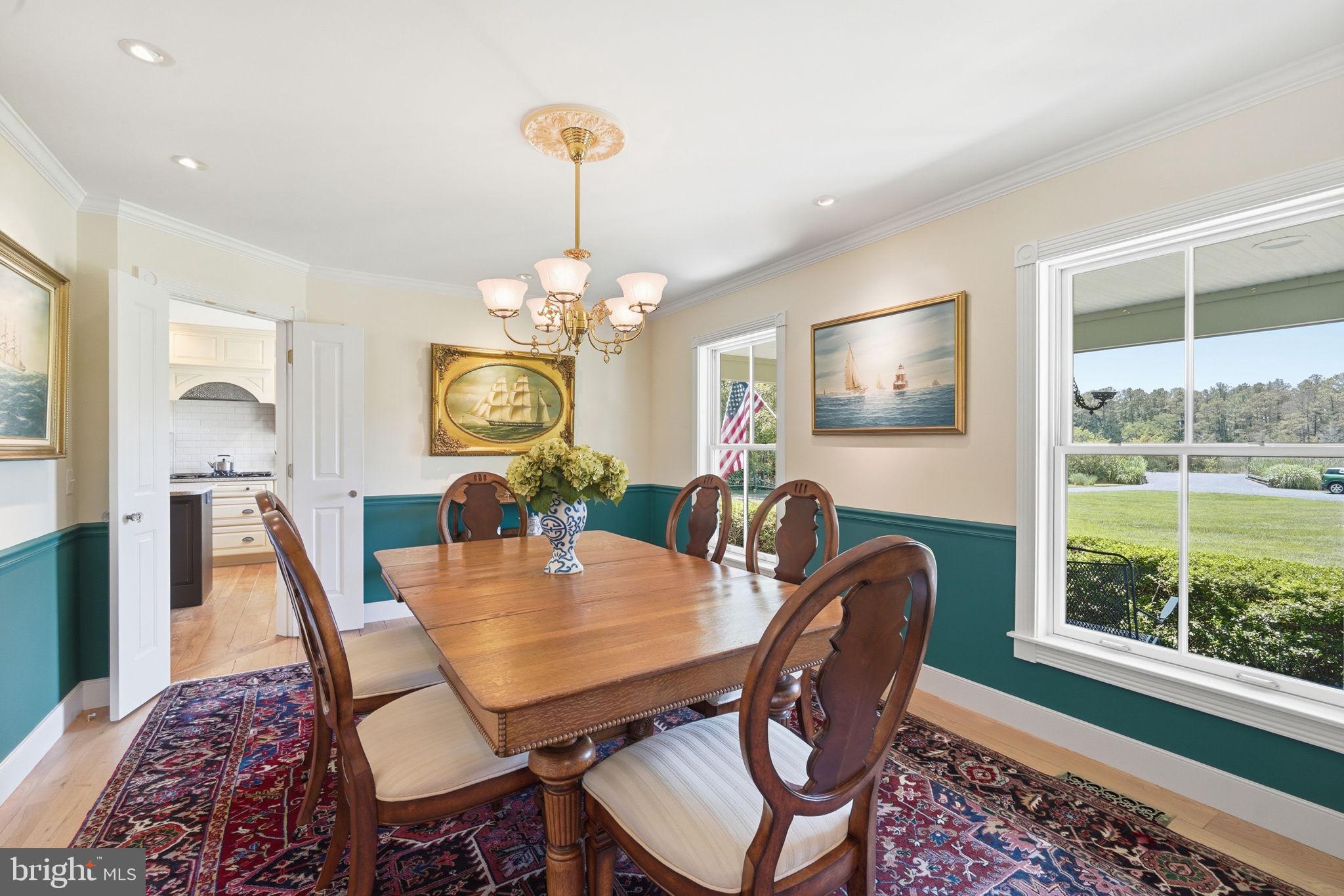 26226 Langs Landing Road Oxford, MD 21654 - Photo 13 of 48 a view of a dining room with furniture window and wooden floor