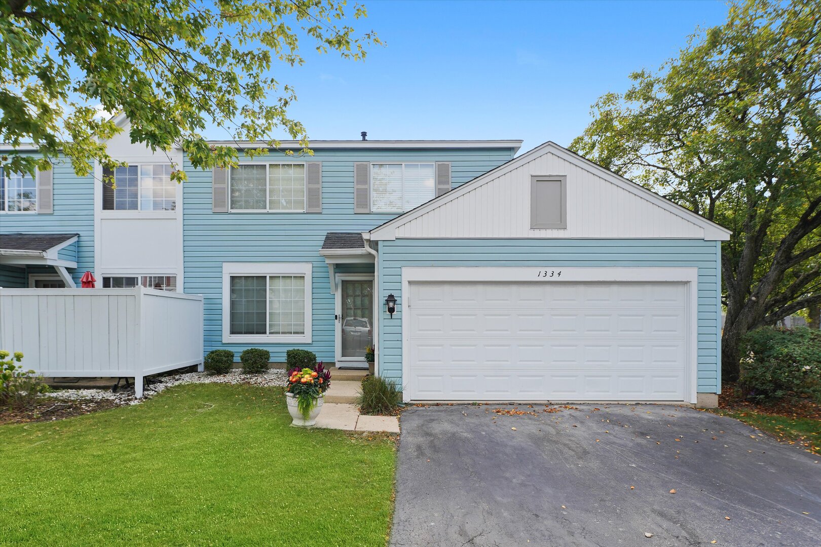 a view of a house with a yard and a garage
