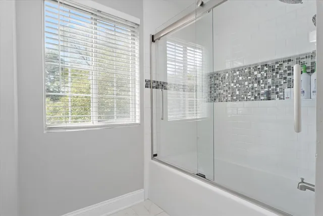 a bathroom with a bathtub and shower