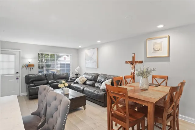 a living room with furniture kitchen and a table
