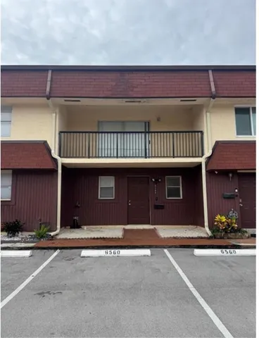 a couple of cars parked in front of a house