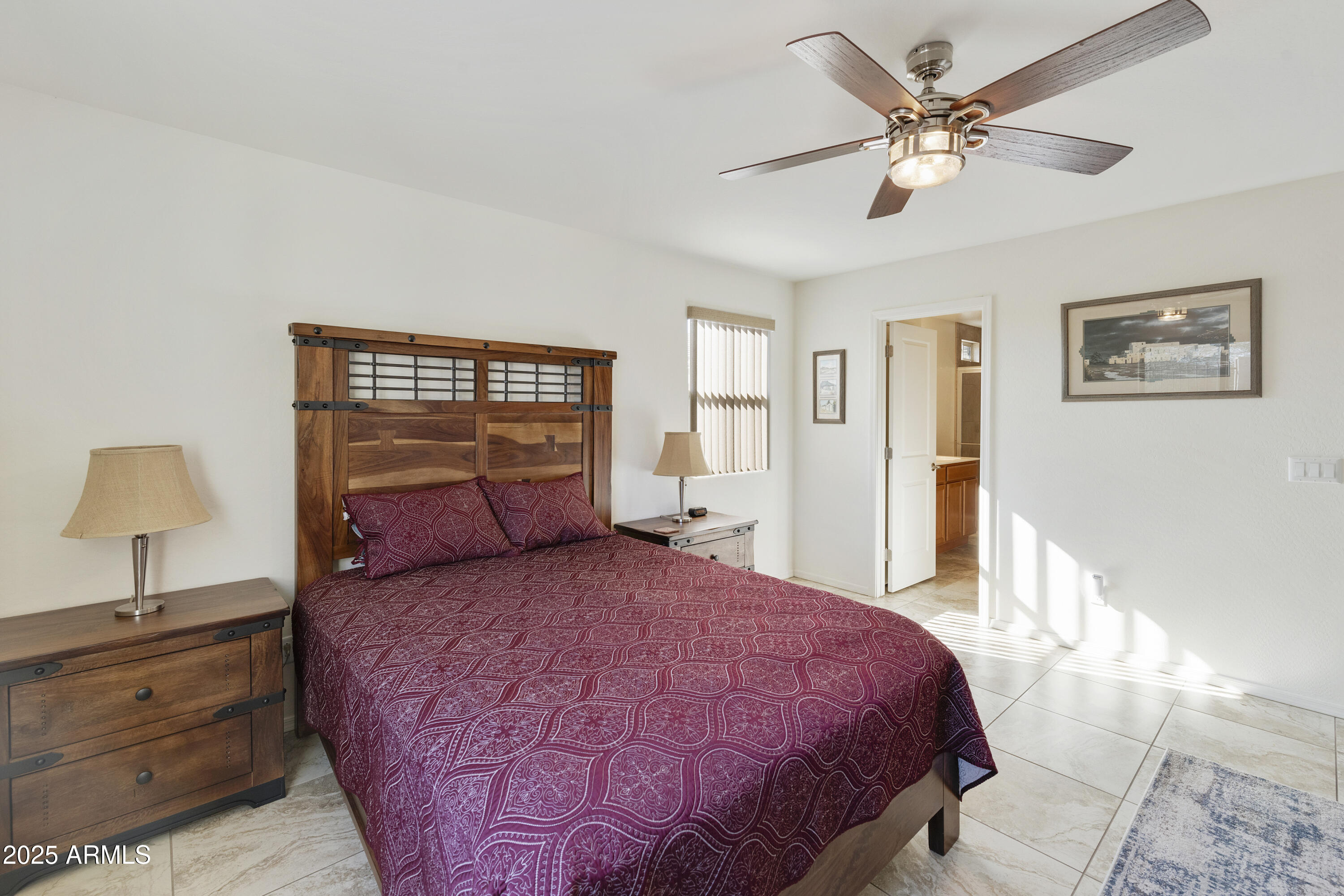 1740 East 16th Avenue Apache Junction, AZ 85119 - Photo 15 of 27 a bedroom with a large bed and a chandelier