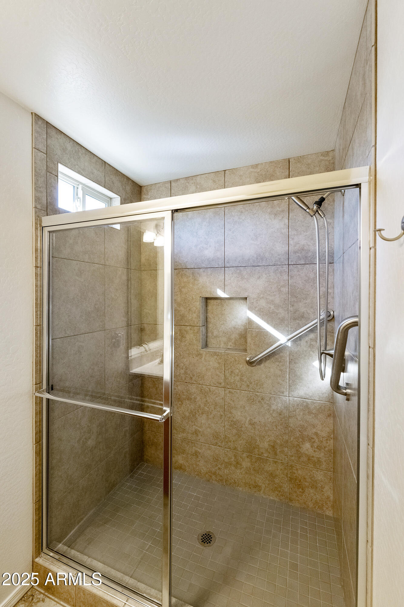 1740 East 16th Avenue Apache Junction, AZ 85119 - Photo 18 of 27 a bathroom with a glass shower door