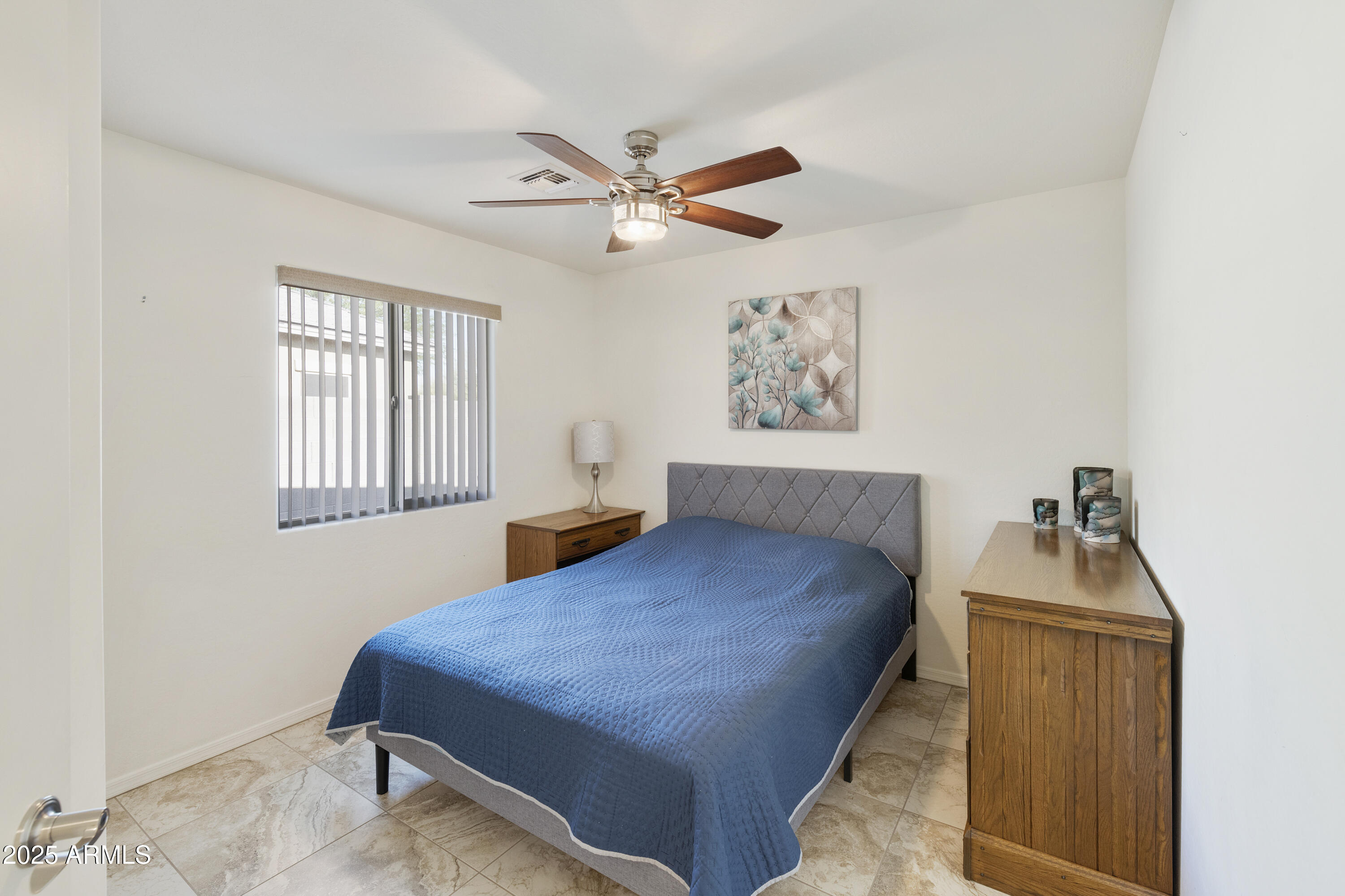 1740 East 16th Avenue Apache Junction, AZ 85119 - Photo 20 of 27 a bedroom with bed and window