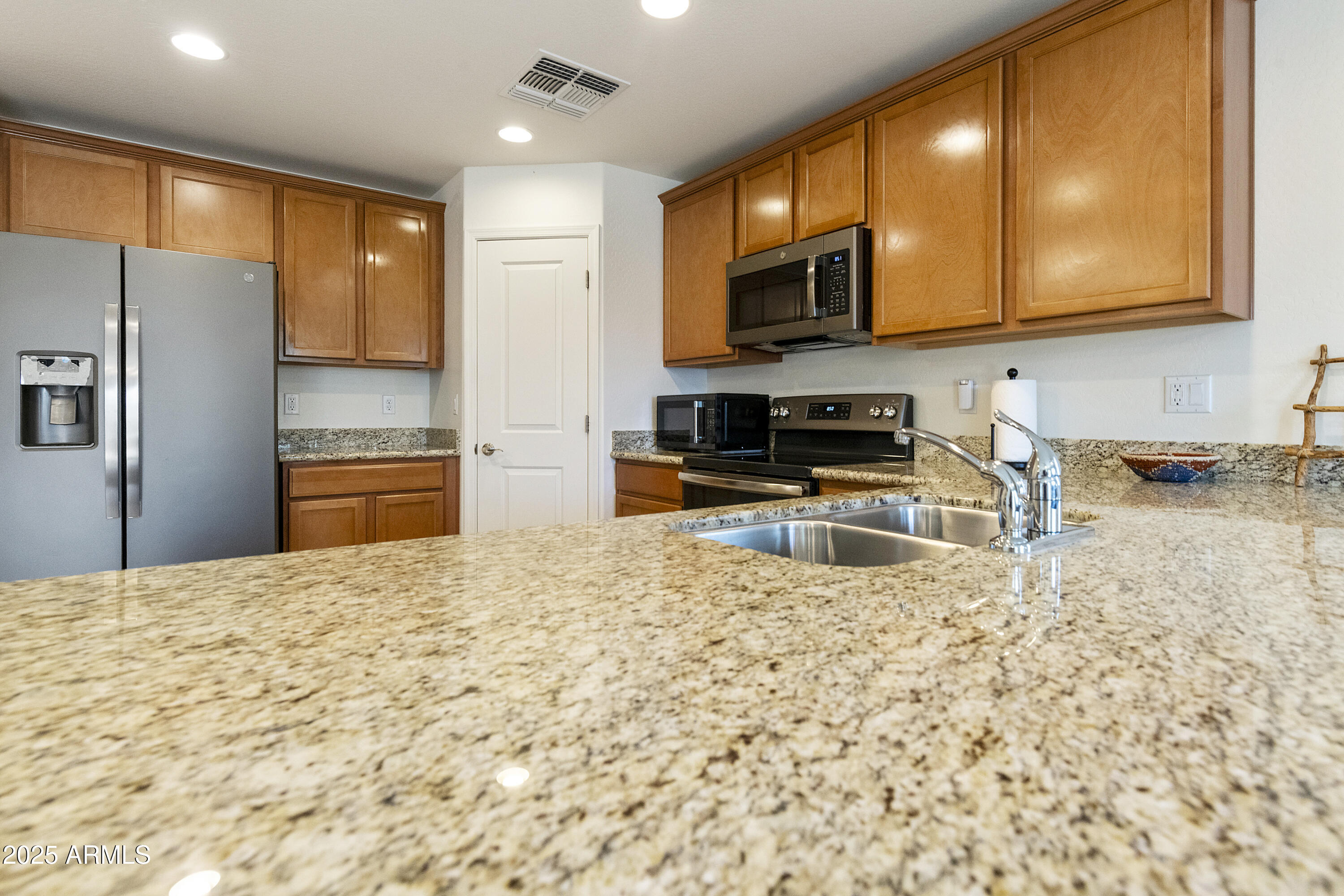 1740 East 16th Avenue Apache Junction, AZ 85119 - Photo 5 of 27 a kitchen with stainless steel appliances granite countertop a refrigerator a stove top oven a sink and dishwasher