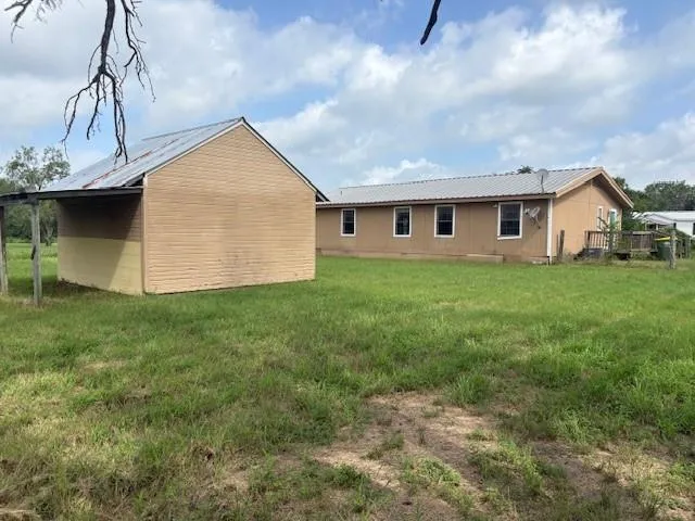 a view of a backyard of the house