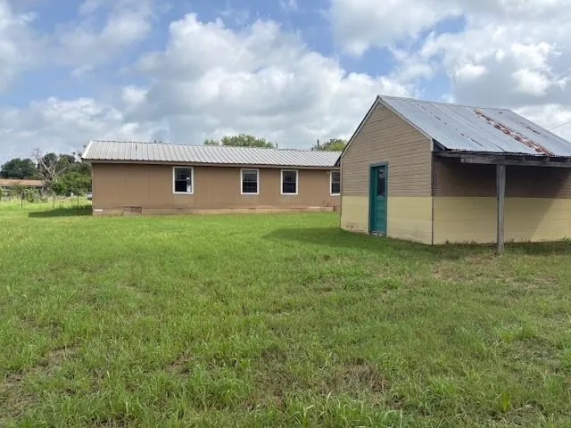 a view of a backyard of the house