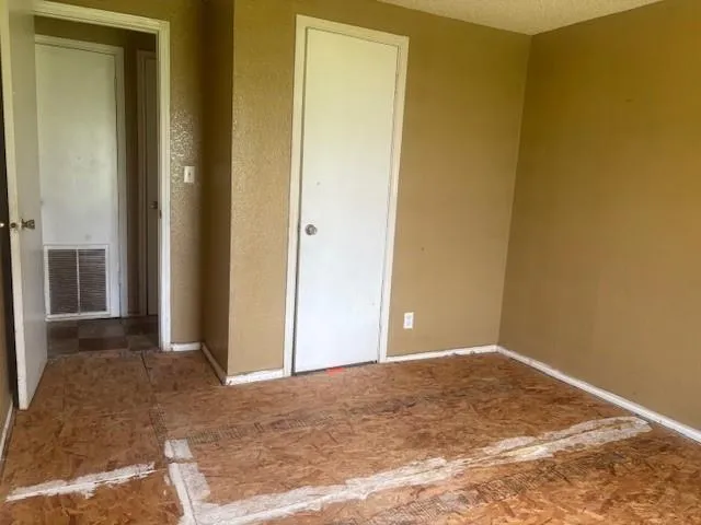 a view of a room with a wooden wall