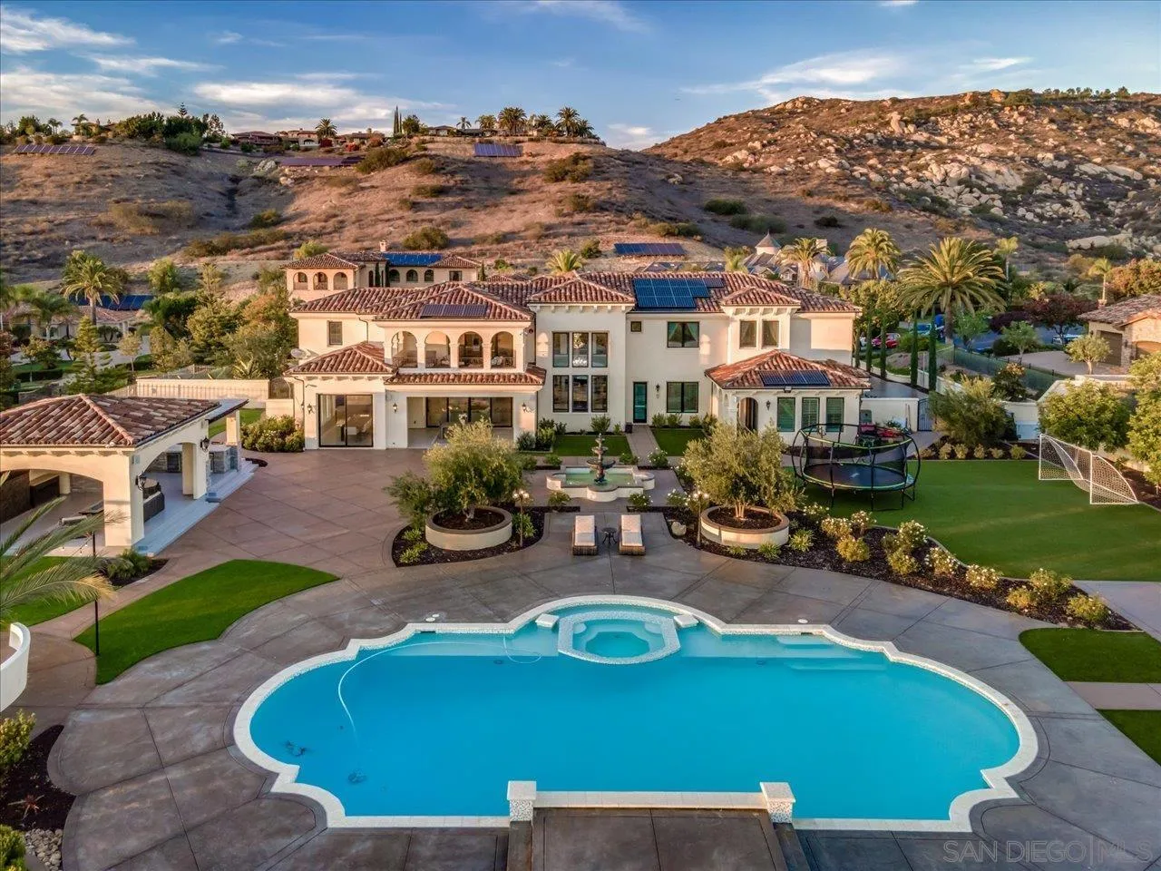an aerial view of a house with swimming pool garden and patio
