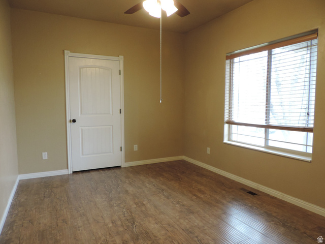 140 North 200 E Street Glenwood, UT 84730 - Photo 13 of 54 Empty room with a ceiling fan and dark wood-style floors