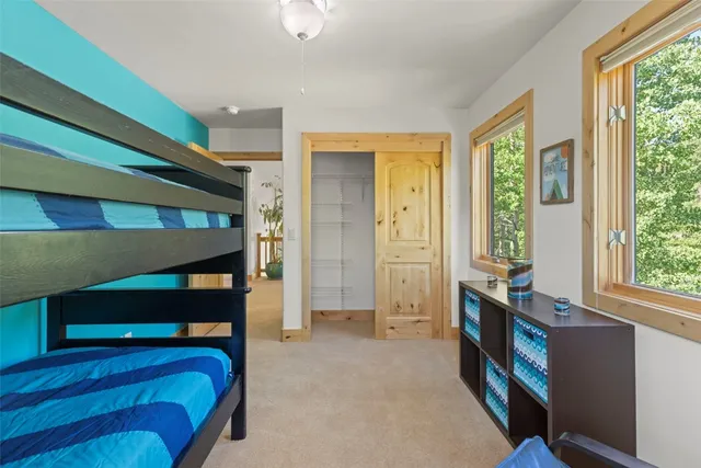 a bedroom with a large bed and a window