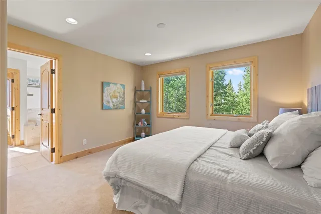 a spacious bedroom with a bed and a view of bathroom