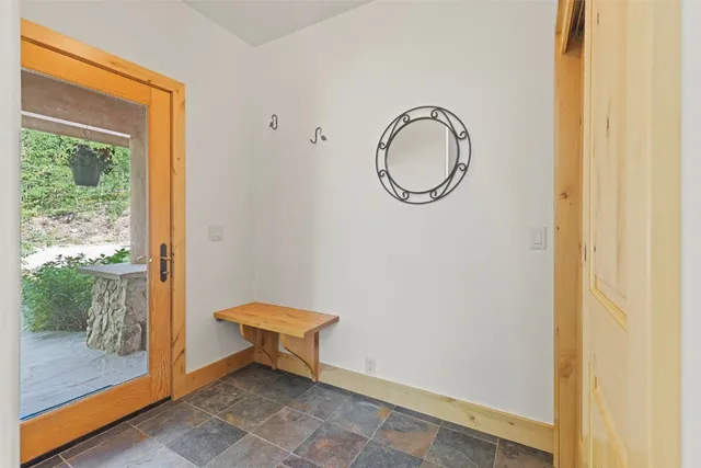 a backyard of a house with lots of plants and trees