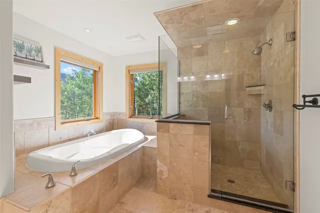 a bathroom with a granite countertop sink a toilet and shower