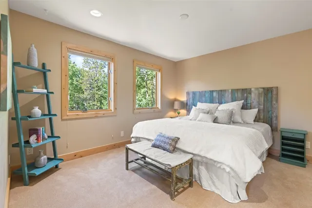 a spacious bedroom with a bed and a window