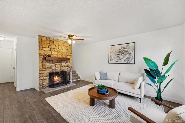 a living room with furniture and a fireplace