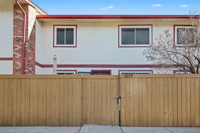 a view of a building with wooden fence