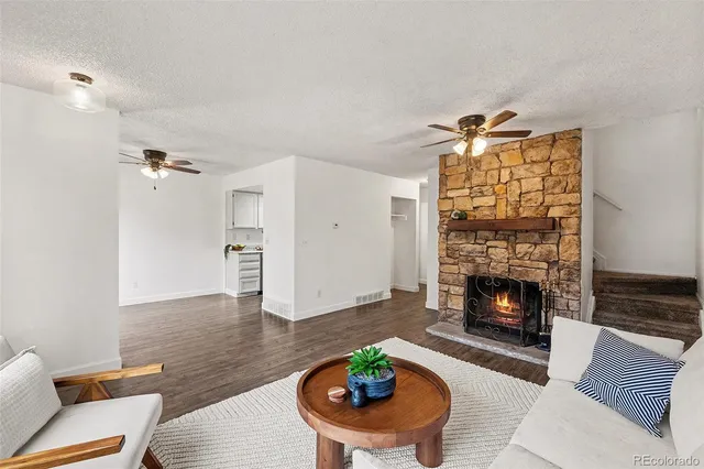 a living room with furniture and a fireplace