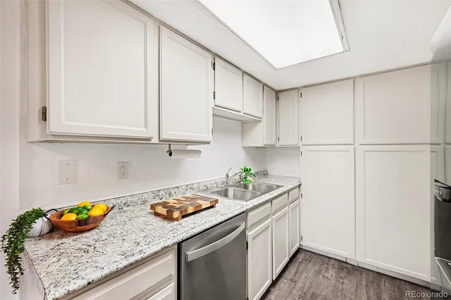 a kitchen with stainless steel appliances granite countertop a sink a stove and cabinets