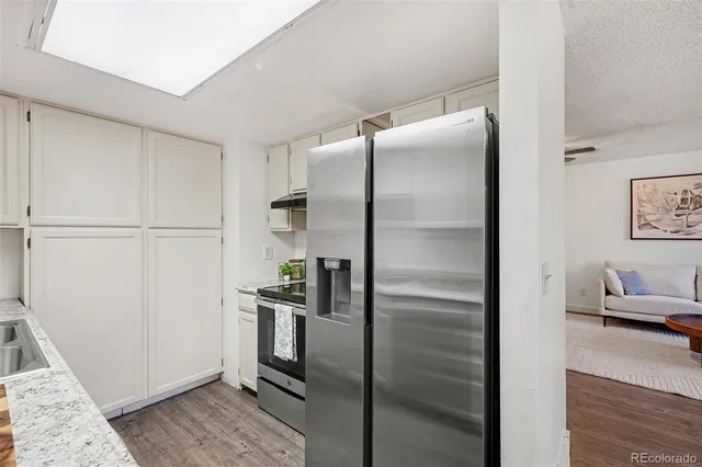 a kitchen with a refrigerator and a stove