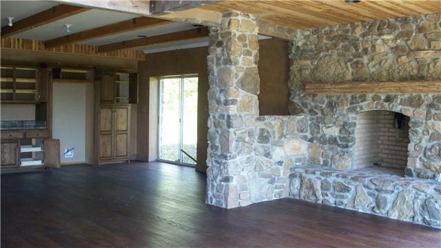 48 Mt Lebanon Road Lawrenceburg, TN 38464 - Photo 3 of 10 a view of empty room with wooden floor and fireplace