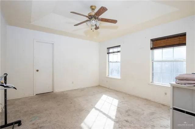 a view of room with a ceiling fan and window