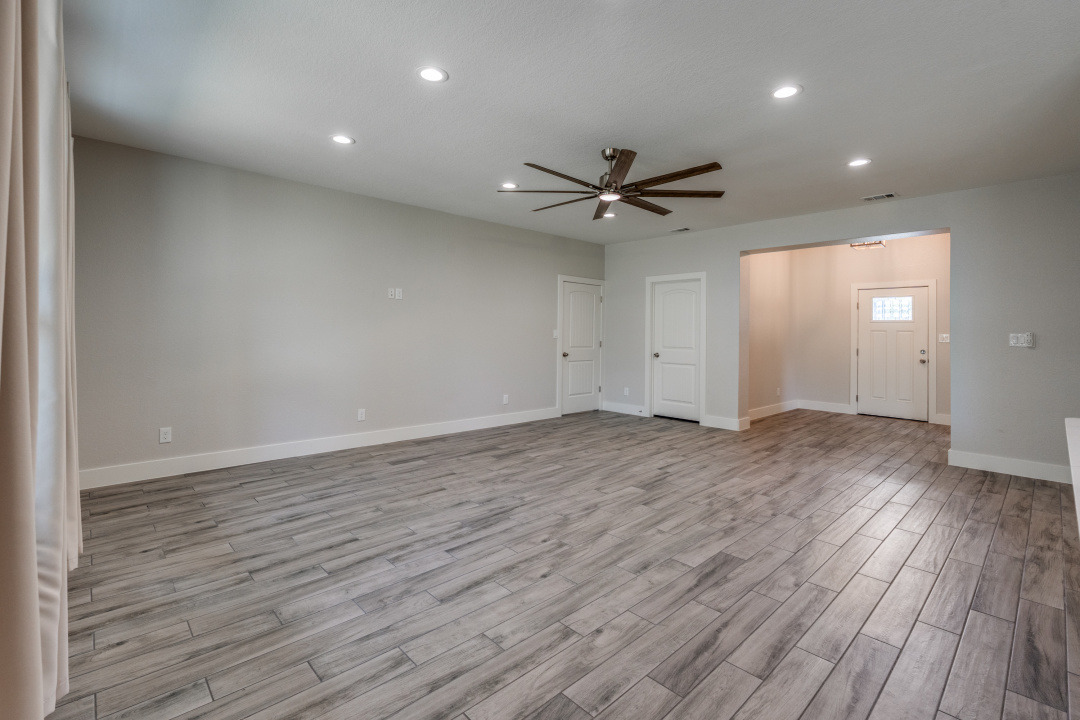 1848 Tanglewood Trail Spring Branch, TX 78070 - Photo 6 of 12 The open-concept living space features wood-look tile flooring and recessed lighting throughout.