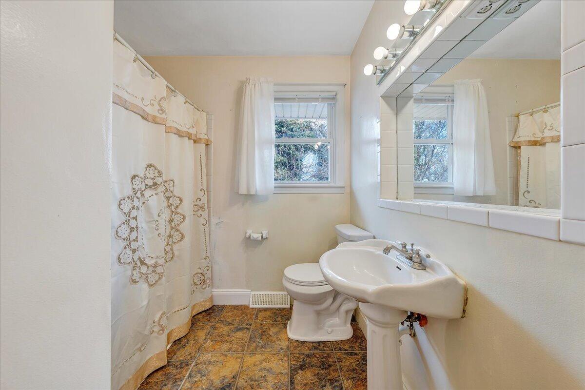 1707 Glendon Road Salem, VA 24153 - Photo 18 of 41 a bathroom with a sink toilet and shower