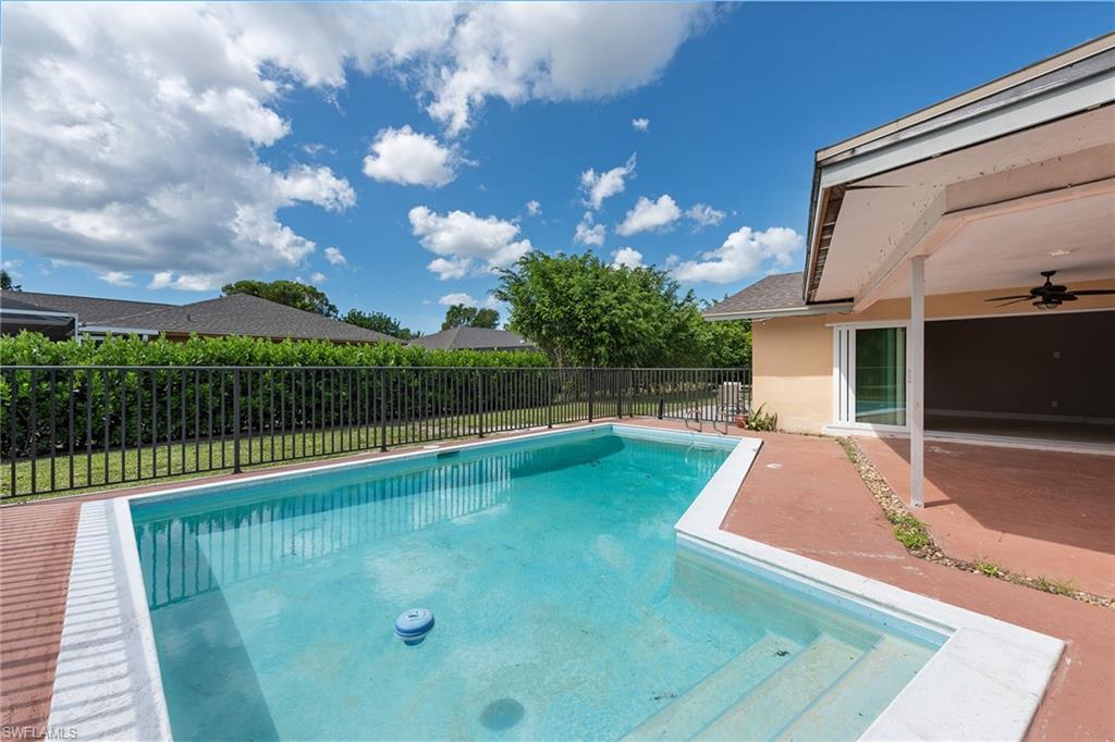 280 Baltusrol Drive Naples, FL 34113 - Photo 12 of 13 a view of a house with a swimming pool